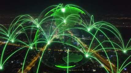 Aerial view of a city at night, featuring a green digital globe overlay, symbolizing global unity and sustainability. - Powered by Adobe