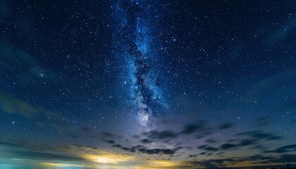 Vibrant milky way galaxy stretching across a dark night sky with clouds