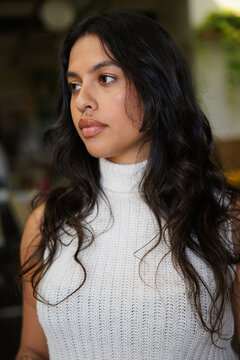 Portrait of a thoughtful woman indoors with natural light 