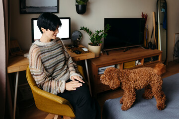 Woman Interacts With Dog at Home Office During Daytime