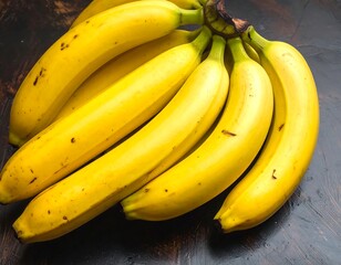 A cluster of ripe, yellow, slightly spotted fruit on a dark brown surface. The bananas appear fresh and ready to eat
