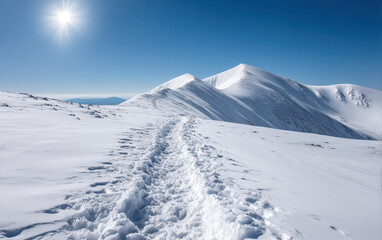 Serene snowy landscape features winding ski trail leading through mountain pass under bright sun. untouched snow glistens, creating peaceful atmosphere perfect for winter adventures
