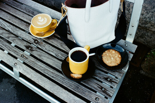 Coffee and cookie time on a wooden bench