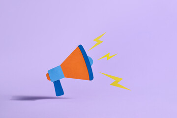 A vibrant paper megaphone shouts out with yellow lightning