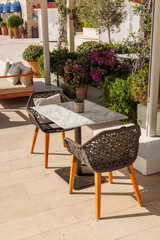 Cozy table on a Mediterranean restaurant terrace on a sunny day