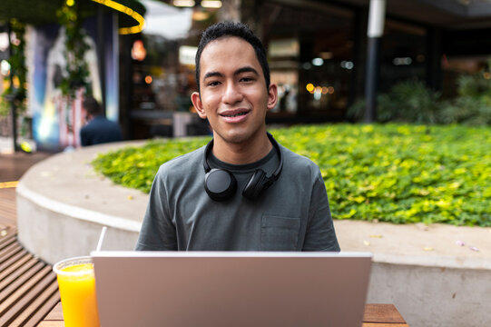 Content creator working with laptop in outdoor workspace