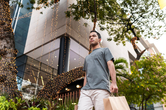 Man shopping under festive holiday lights