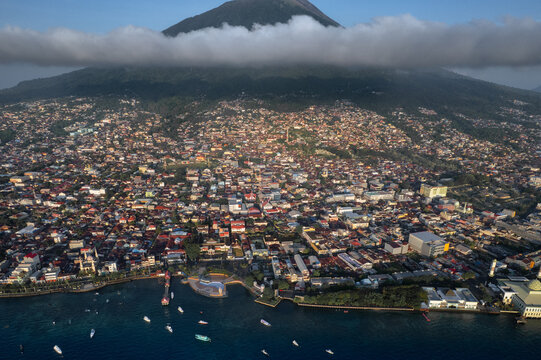 City of Ternate with volcanic mountain under clouds