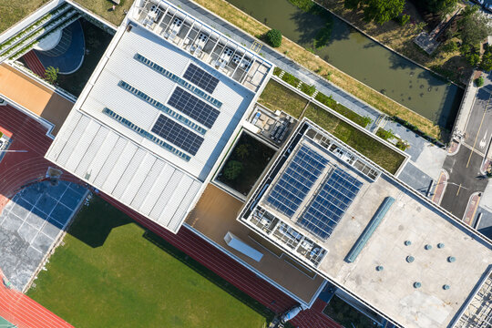 Aerial view of modern building rooftops with solar panels