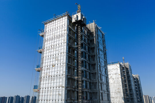 High rise building under construction with workers
