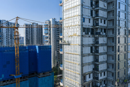High rise building under construction with workers