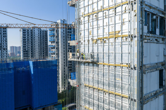 High rise building under construction with workers