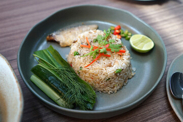Close up stir fry rice served with mackerel fish and fresh vegetables