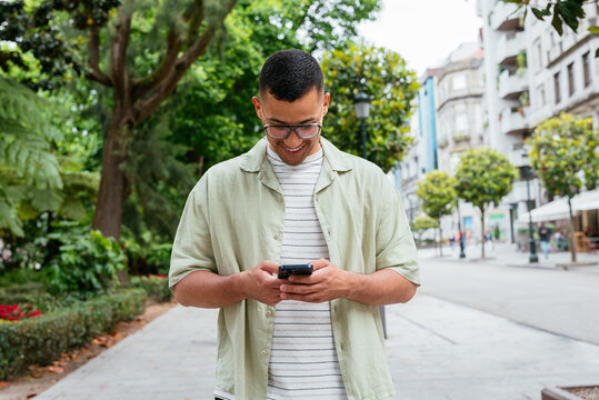 Happy Man using Smartphone Outdoors