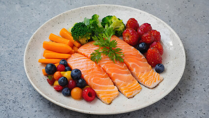 Salmon Fillets with Berries, Broccoli, Carrots, and Tomatoes on Plate