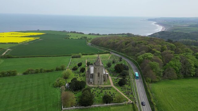 Aerial drone footage of St Oswald&rsquo;s Church, Lythe, North Yorkshire, showcasing its historic architecture, coastal views, and scenic village surroundings.