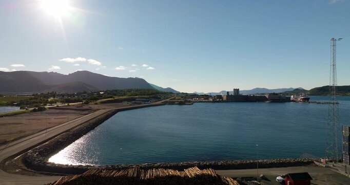Drone glides over Stokmarknes harbor and coastline in Vester&aring;len, Aerial