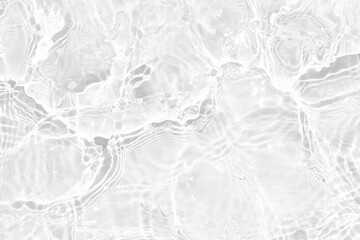 White water with ripples on the surface. Defocus blurred transparent white colored clear calm water surface texture with splashes and bubbles. Water waves with shining pattern texture background.