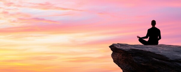 Wellness fitness holistic concept. Serene figure meditating on a rock at sunset, surrounded by vibrant sky colors.