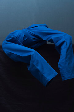 Man Dressing in Blue Against Tonal Backdrop
