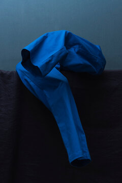 Man Dressing in Blue Against Tonal Backdrop