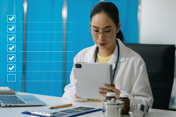 Business performance checklist concept, doctor using tablet and laptop doing online checklist...