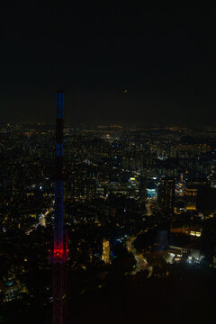 Seoul City Skyline View With Lights and a Crescent Moon at Night