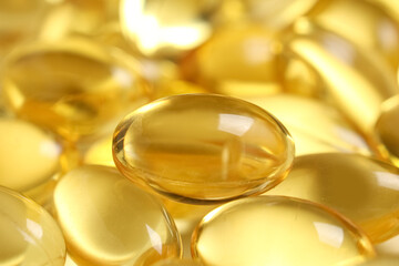 Texture of vitamin E capsules as background, closeup