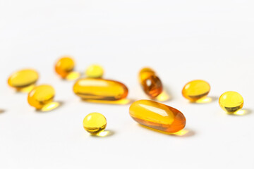 Vitamin E capsules on white background, closeup