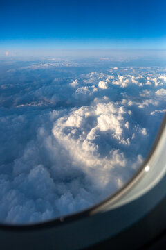 High Clouds Viewed From an Airplane Window During Daytime Flight