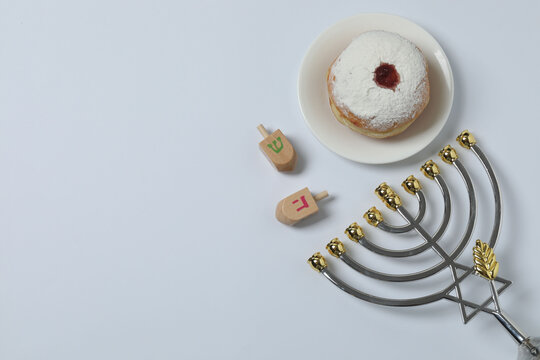 Hanukkah celebration with menorah, dreams, gifts and traditional donuts on a white background.
- Powered by Adobe