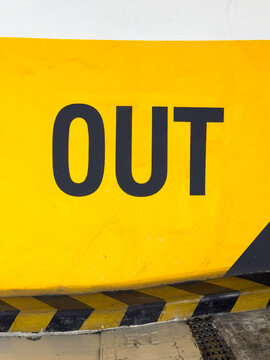 Clear Signage Indicating Exit (OUT) in a Parking Garage at Daylight