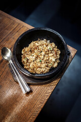Fried Rice In Black Bowl On Wooden Table With Spoon - Home Cooked Asian Meal