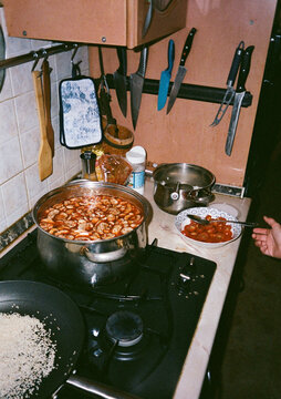 Cooking a Flavorful Tom Yam Dish in a Cozy Kitchen Setting