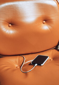 Padded leather chair and smartphone 
