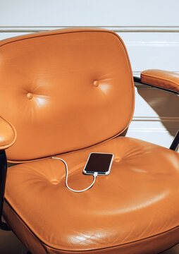 Padded leather chair and smartphone 