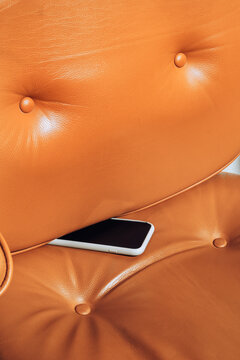 stuck smartphone in leather cushion