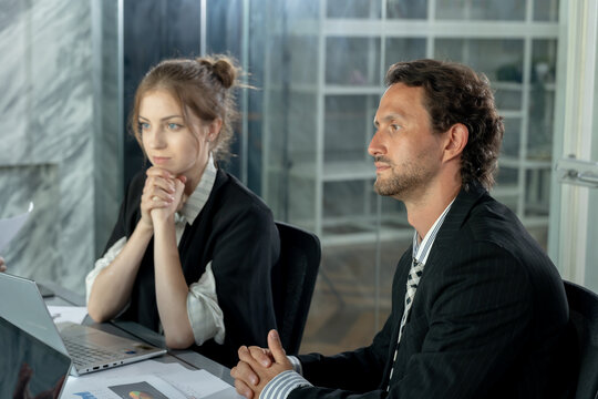 Multiracial team discussing financial data during office meeting, caucasian female listening while male colleague explaining strategy, teamwork and collaboration in professional environment - Powered by Adobe