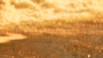 Bokeh Water Light, blurred golden reflections on water surface at golden hour, background texture.