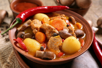 Bowl of tasty beef stew with chili pepper, closeup