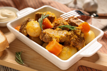 Baking dish of tasty beef stew with rosemary, closeup