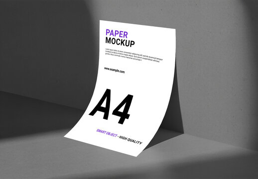 A4 Paper Mockup Against Corner Wall with Dramatic Studio Shadows