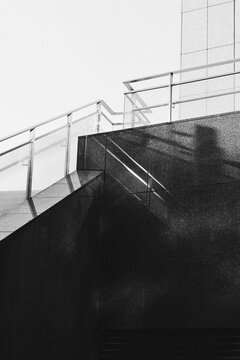 Architectural staircase shadows on dark urban building facade