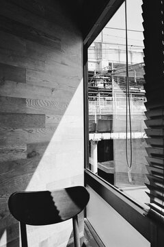 Minimalist interior with wooden chair and window light in Tokyo