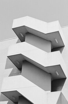 Modern zigzag staircase on tiled urban building exterior
