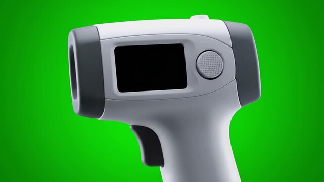 A close-up of a contactless infrared thermometer against a green backdrop