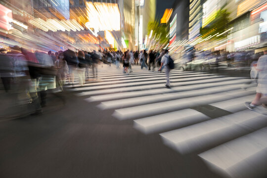 Fast moving crowd on city street at night