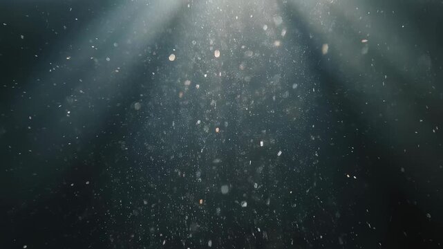 Light through dust motes against a dark, grainy background