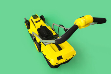 Fototapeta premium Modern lawn mower on green background