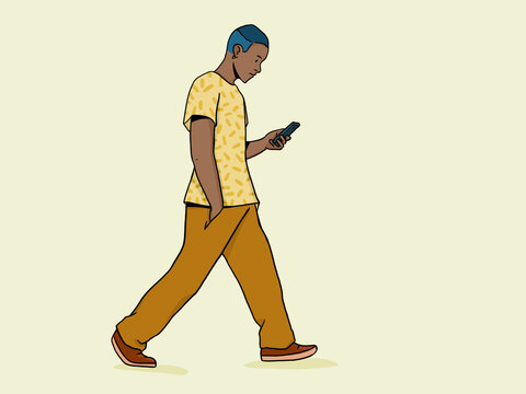 Young man walking distracted using mobile phone